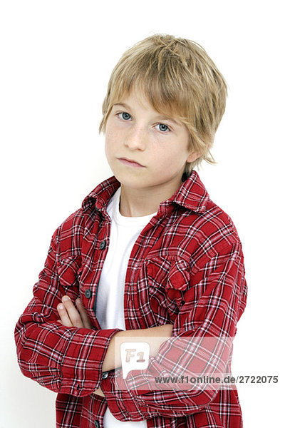 Boy (10-11) standing with arms crossed  portrait  close-up