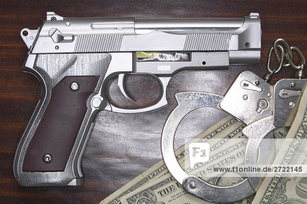 Plastic pistol  Crime money  elevated view