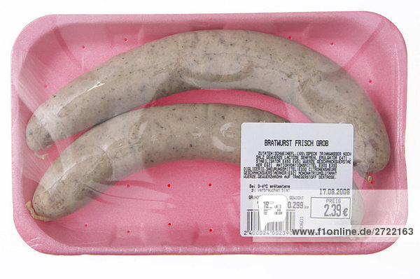 Fresh pork sausages in styrofoam plate  close-up