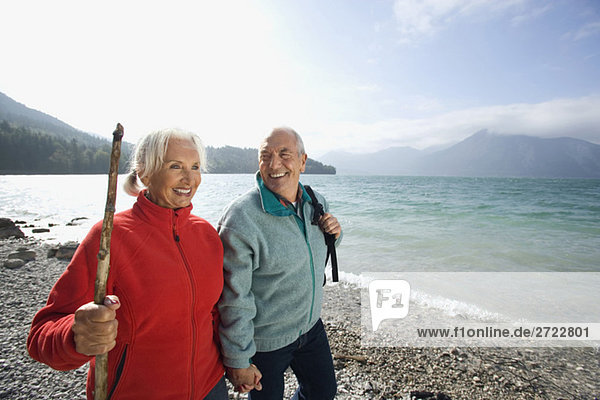 Germany  Bavaria  Walchensee  Senior couple hiking on lakeshore
