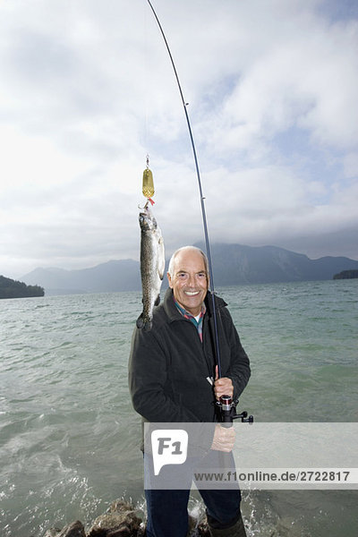Senior man fishing in lake