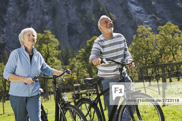 Austria  Karwendel  Ahornboden  Senior couple pushing bikes