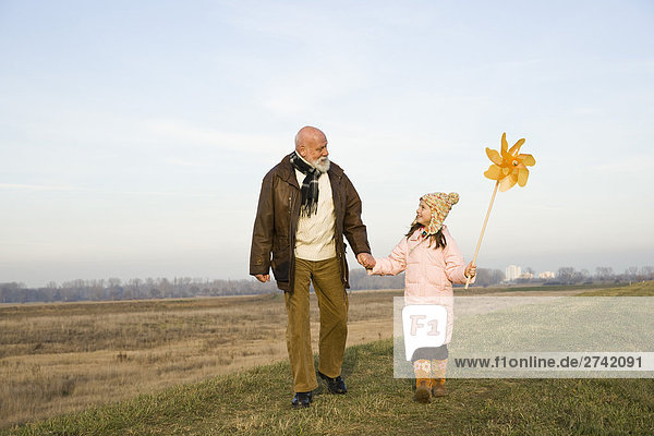 Mädchen hält Nadelrad mit ihrem Großvater