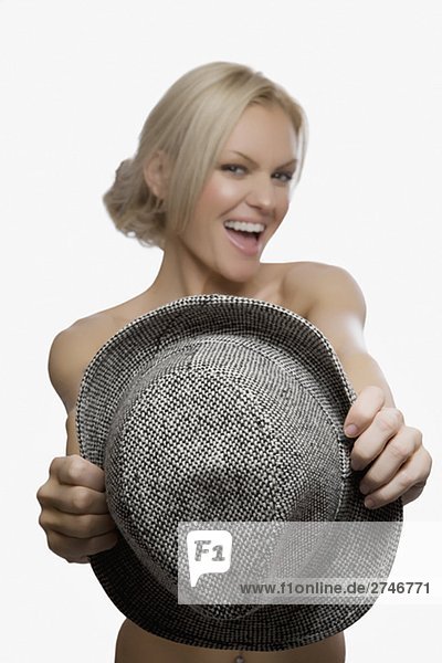 Portrait of a junge Frau hält einen Hut