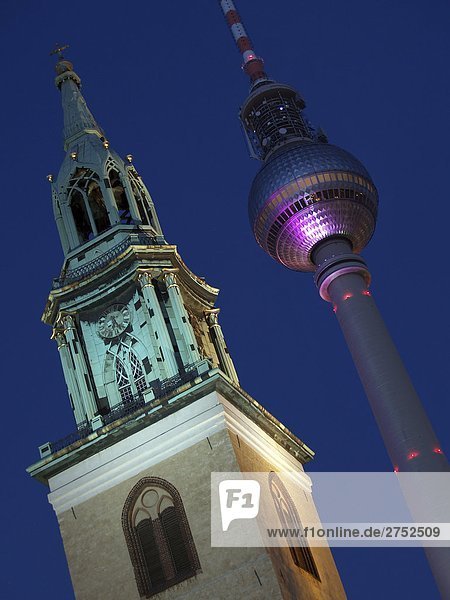 Low angle view of communication tower and church spire