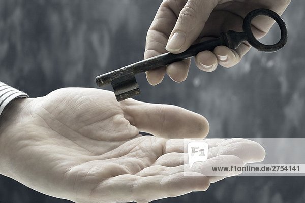 Close-up of person's hand handling key