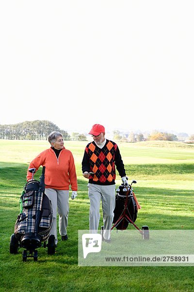 An elderly couple playing golf Skane Sweden.