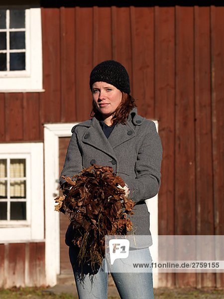 A Scandinavian woman with autumn leaves Sweden.
