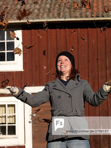 A Scandinavian woman with autumn leaves Sweden.