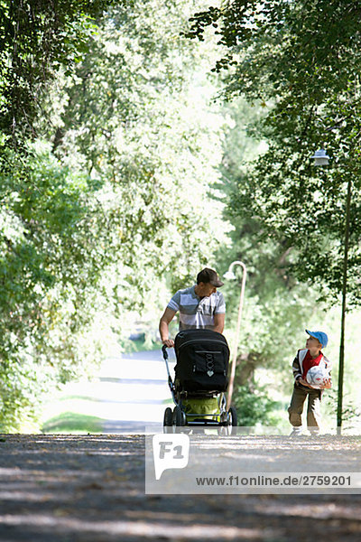 Father and son walking in a park a sunny day Sweden.