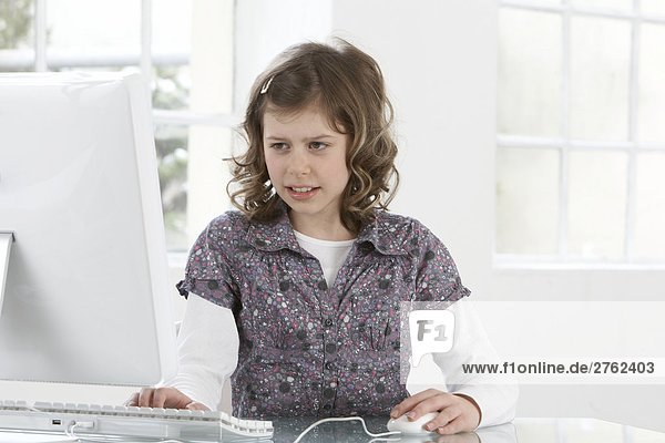 Close-up of girl working on computer