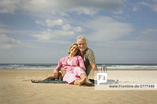 Couple sat on a beach