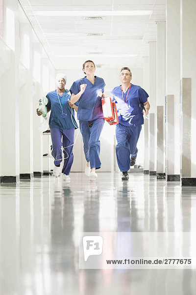 Three medical staff running