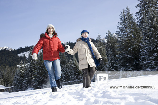 Tourists enjoying in snow covering landscape