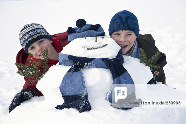 Friends playing with snowman