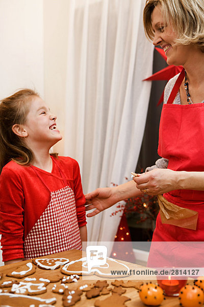 Mother and daughter baking gingerbread biscuits Sweden.