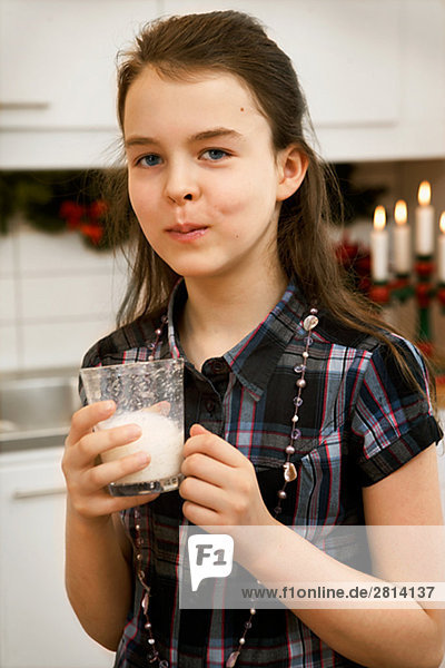 A girl drinking milk.
