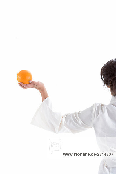 Woman holding an orange Sweden.