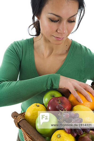 A woman holding a basket of fruits Sweden.