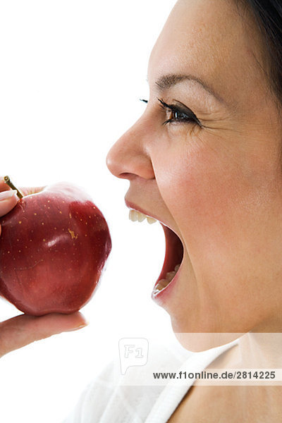 A woman eating an apple Sweden.