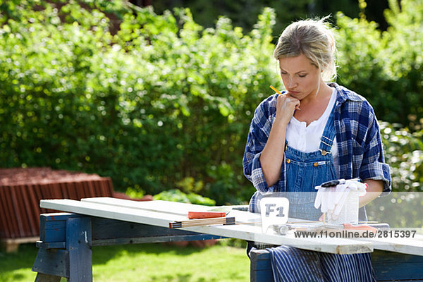 Eine Frau Carpentry in einem Garten Schweden zu tun.