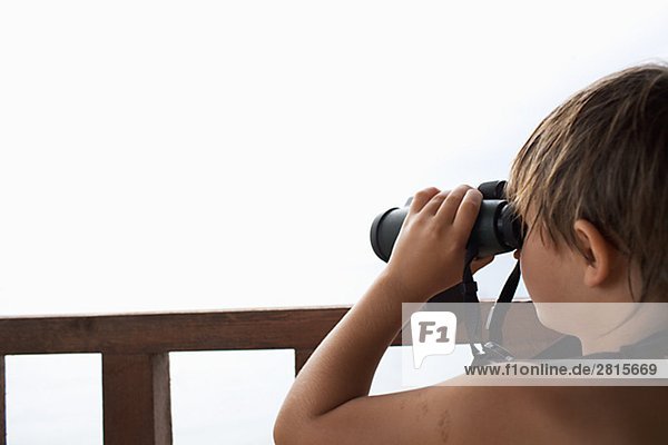 A boy using binoculars Greece.