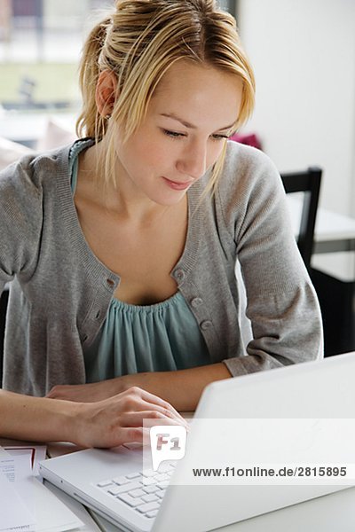 A woman using a laptop in a cafÈ Sweden.