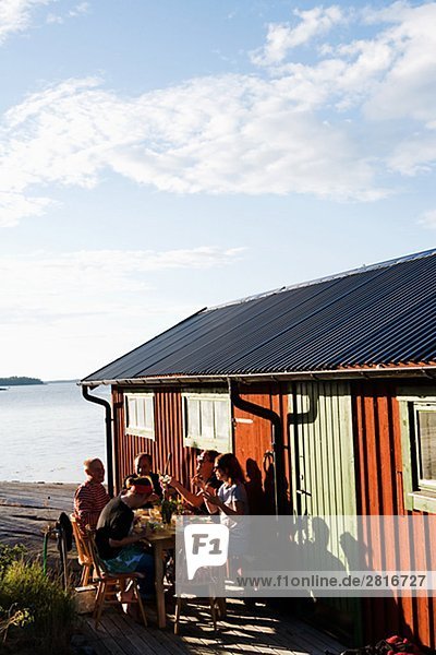 Dinner by a boathouse in the archipelago of Stockholm Sweden.