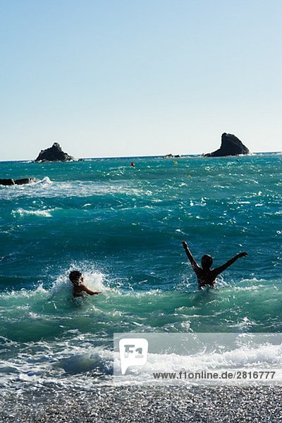Two persons swimming in the sea Spain.