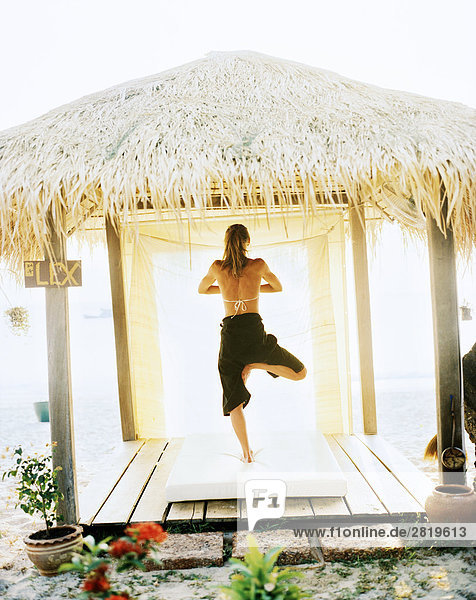 A Scandinavian woman performing yoga Thailand.
