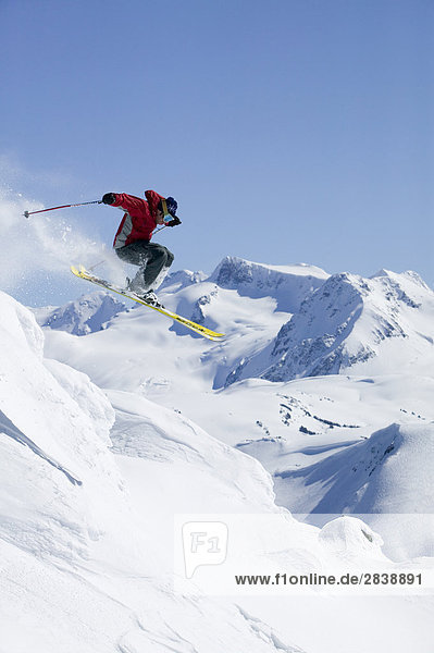 Skier getting air in Whistlers backcountry  British Columbia  Canada.
