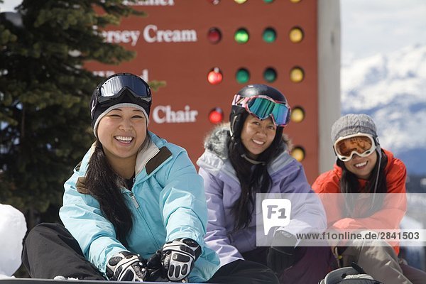 Young asian female skiers and snowboarders  Whistler Mountain  British Columbia  Canada.
