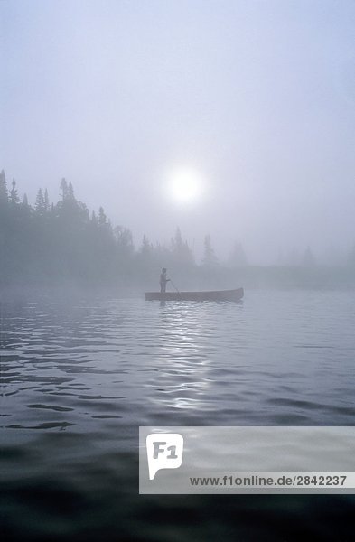 Poling Canoe  Silver Mountain Lodge  Salmon Fishing in fog on the Upper Humber River  Newfoundland  Canada