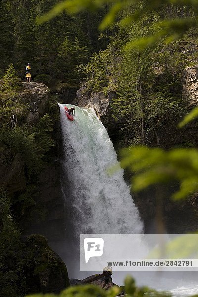 A kayaker running the 60 foot Sutherland Falls  Revelstoke  British Columbia  Canada.