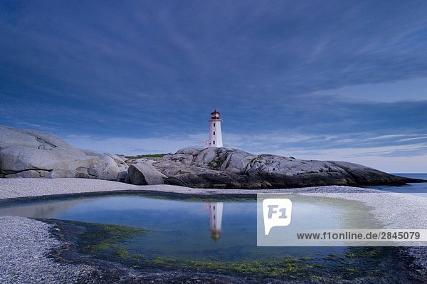 Lighthouse reflected in tide pool  Peggy's Cove  Nova Scotia  Canada