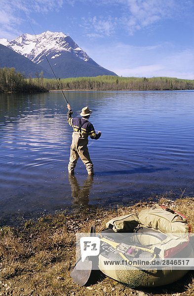 Flyfisherman beside lake  Ross Lake Provincial Park  Hazelton  British Columbia  Canada.