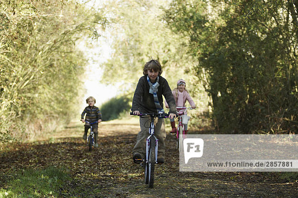 Children riding bikes in countryside