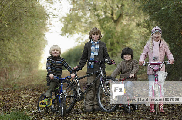 Children with bikes on country lane