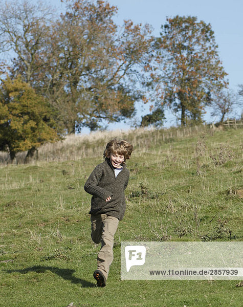 Young boy running in countryside