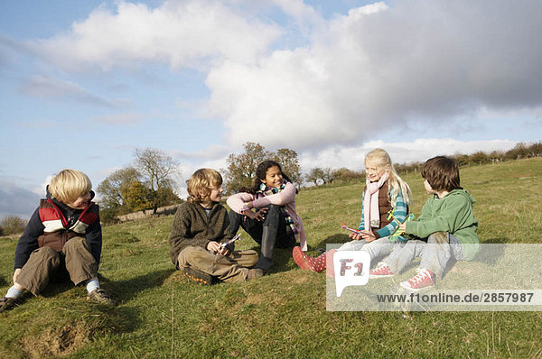 Group of children sitting on hill