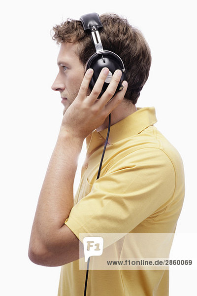 Young man wearing headphones  side view  portrait