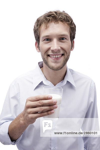 Young man holding a glass of milk  portrait
