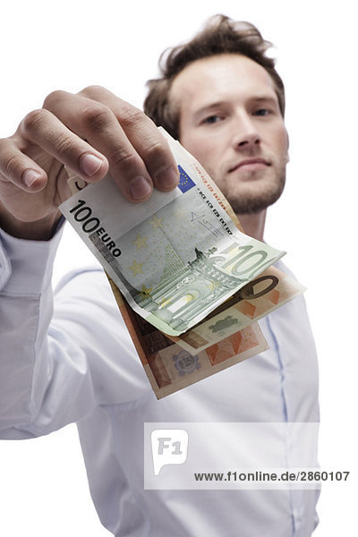 Young man holding Euro notes  portrait