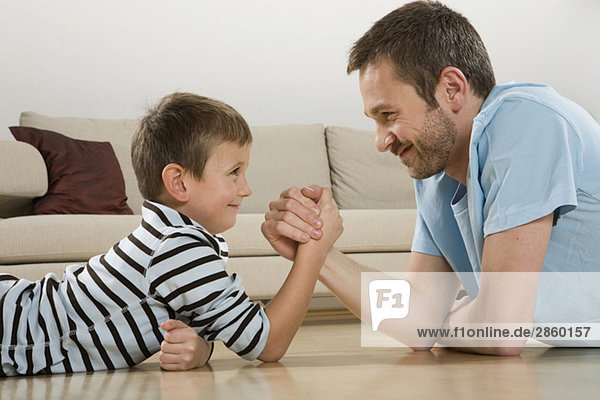 Father and son (4-5)  arm wrestling
