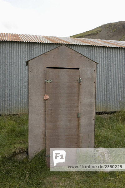 Iceland  Person hiding behind door