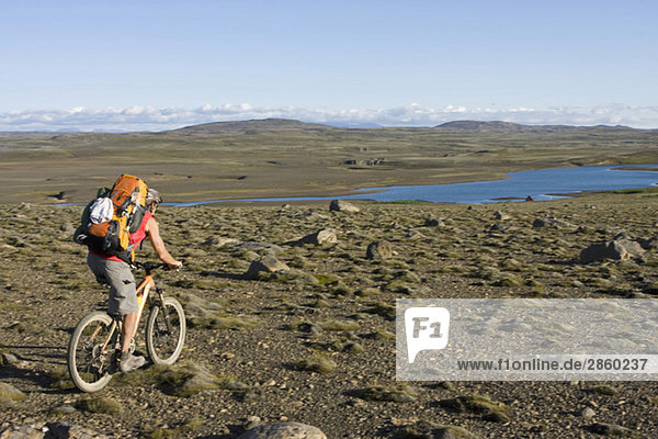 Iceland  Man mountain biking across lowland