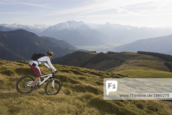 Austria  Salzburger Land  Zell am See  Woman mountain biking