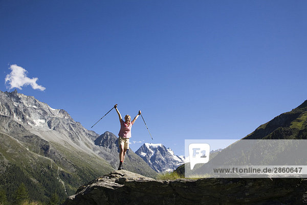 Switzerland  Wallis Alps  Mont Collon  Woman with walking sticks  cheering