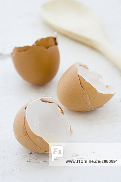 Egg shells and wooden spoon  close-up