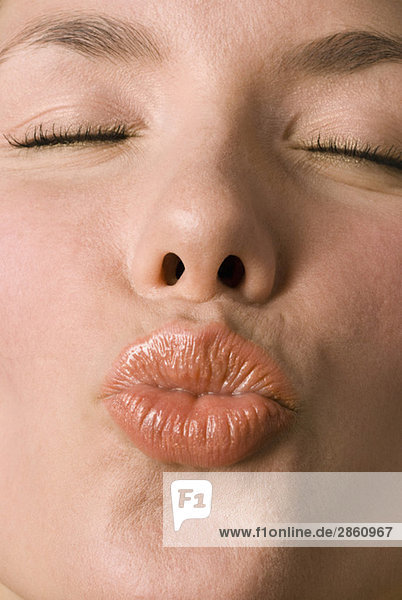 Young woman puckering lips  close up mouth